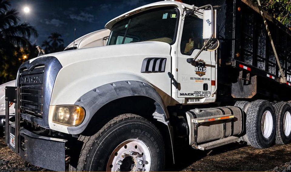 B.O.S. Trucking & Site Mack Granite tri-axle dump truck, lettered with USDOT 1418170 and 239-900-6374, at the Fort Myers yard